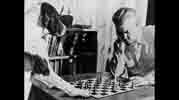 Keller Breland playing chess with a dog